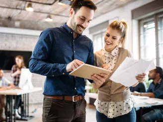 Two people-in office-looking at tablet-lifestyle